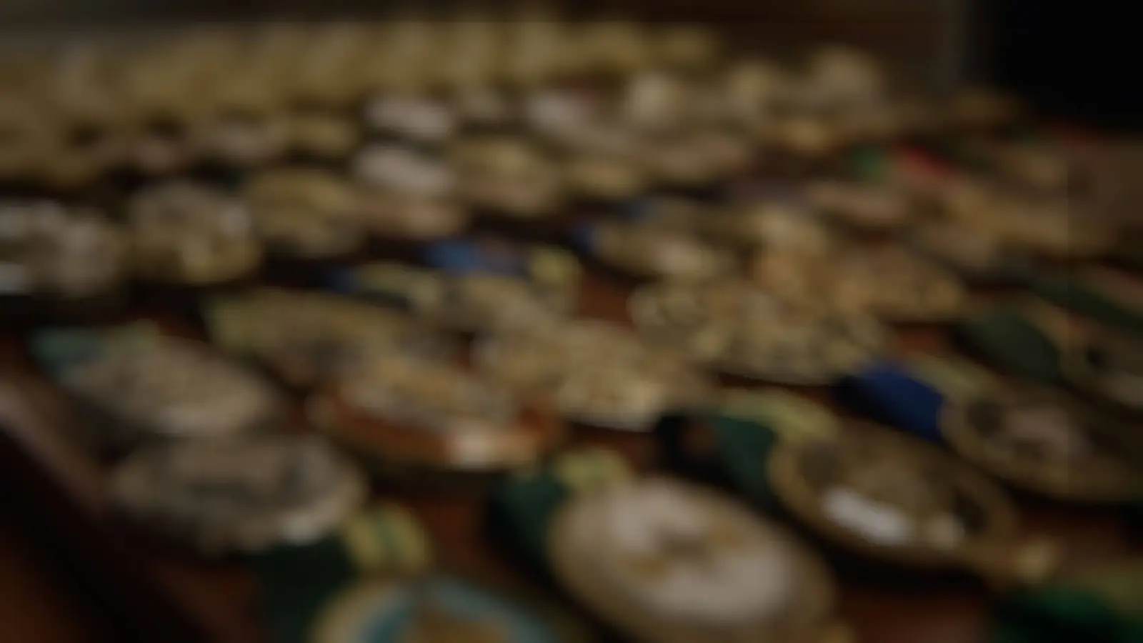 A collection of challenge coins photographed with shallow depth of field